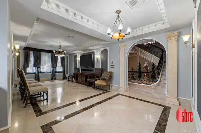 a lobby with furniture and a chandelier