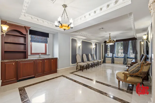 a living room with a couch and a chandelier
