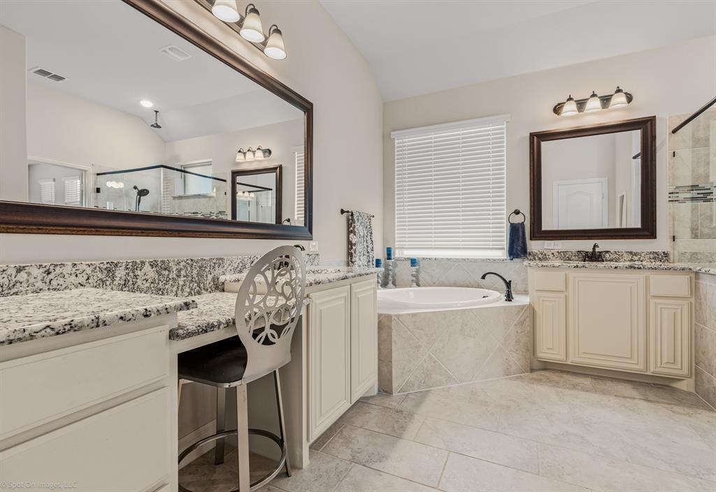 2139 Devonblue Drive Forney, TX 75126 - Photo 14 of 30 Primary Bathroom featuring a deck mounted garden tub, two vanities with granite countertops and knee space, and tile floors