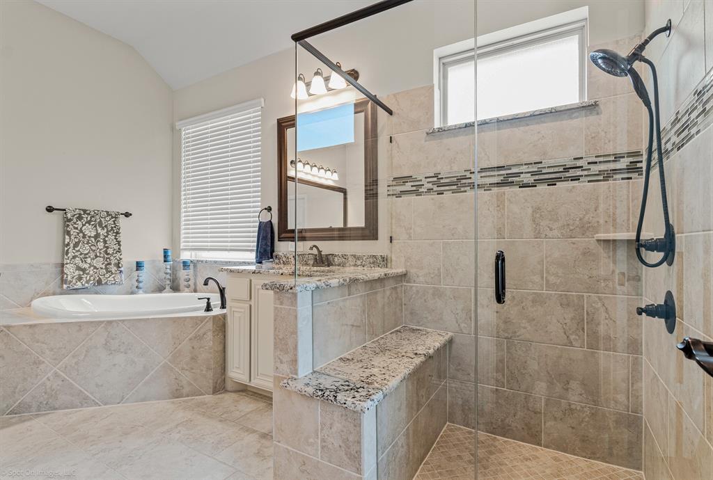 2139 Devonblue Drive Forney, TX 75126 - Photo 15 of 30 Primary bathroom offers oversized shower with sitting area and rainhead faucet, and a separate garden tub.
