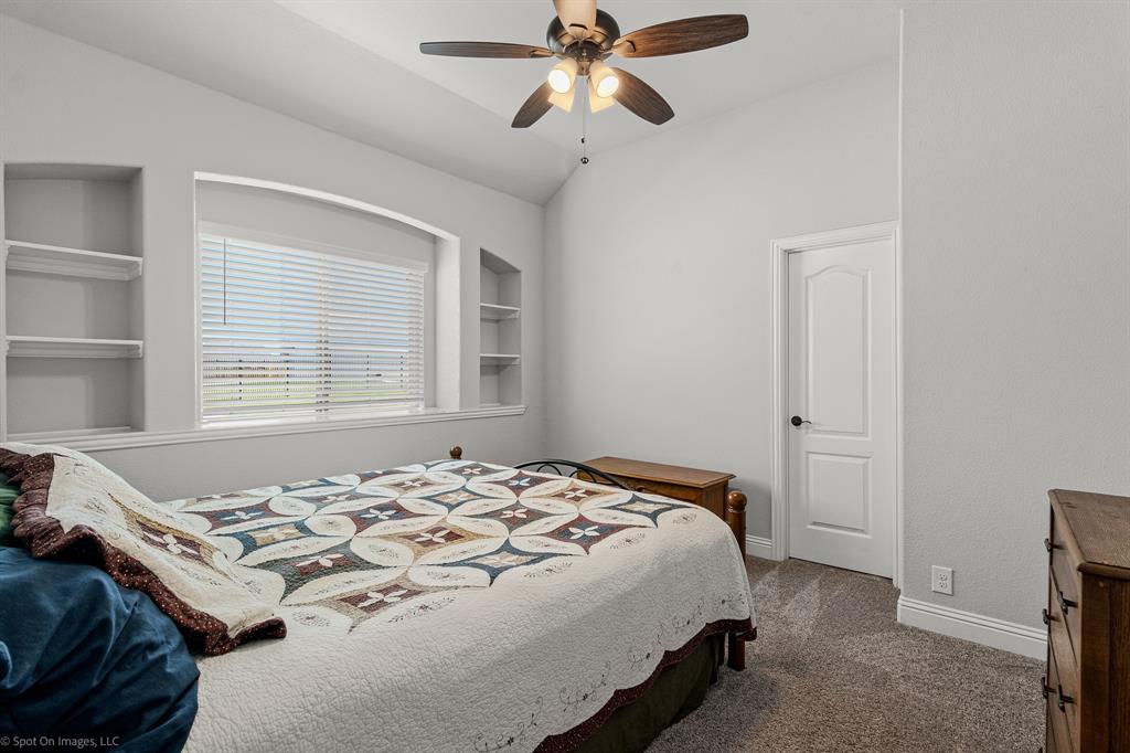 2139 Devonblue Drive Forney, TX 75126 - Photo 16 of 30 Secondary bedroom with built-in shelving and walk-in closet. Carpet