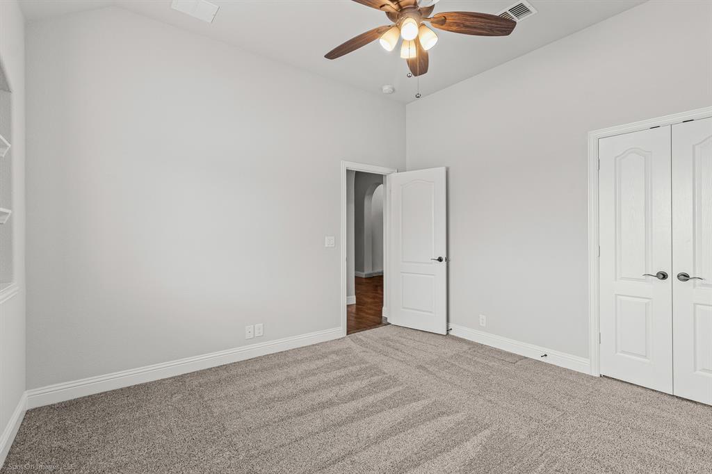2139 Devonblue Drive Forney, TX 75126 - Photo 19 of 30 Secondary bedroom with built-in shelving and walk-in closet. Carpet
