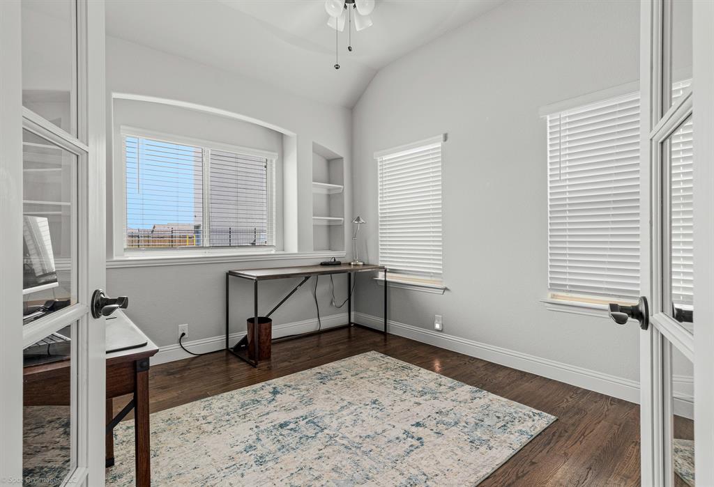2139 Devonblue Drive Forney, TX 75126 - Photo 22 of 30 Bedroom (or office) with built in features, hand-scraped wood floors, walk-in closed and french door.