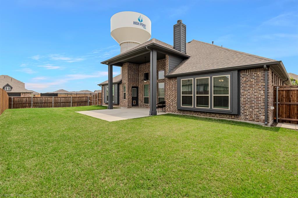 2139 Devonblue Drive Forney, TX 75126 - Photo 25 of 30 Back yard with extended patio cover, ceiling fan, and a 10 x 20 concrete pad addition. Wood fence.