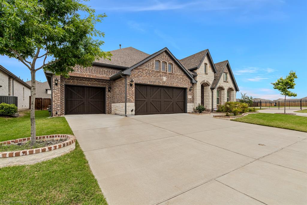 2139 Devonblue Drive Forney, TX 75126 - Photo 30 of 30 French country home with concrete driveway, 3 car garage, brick and stone exterior on a corner lot.