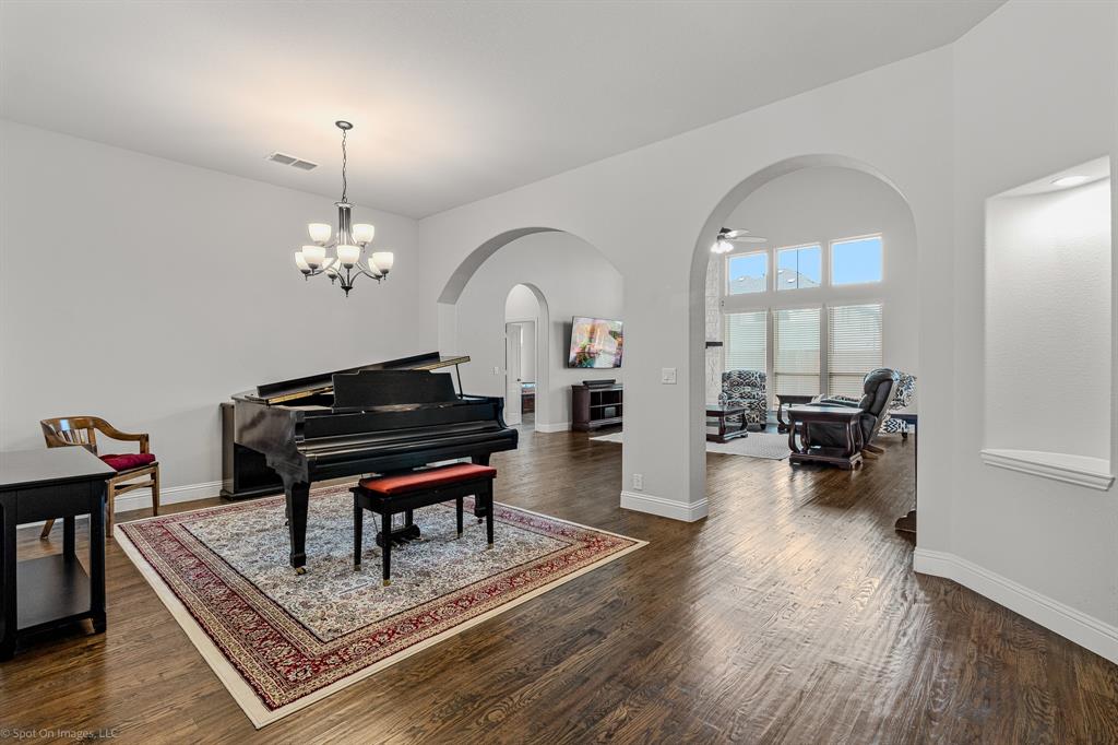 2139 Devonblue Drive Forney, TX 75126 - Photo 3 of 30 Dining Room, or piano room! Arched openings to the open living/kitchen area. Hand-scraped wood floors.