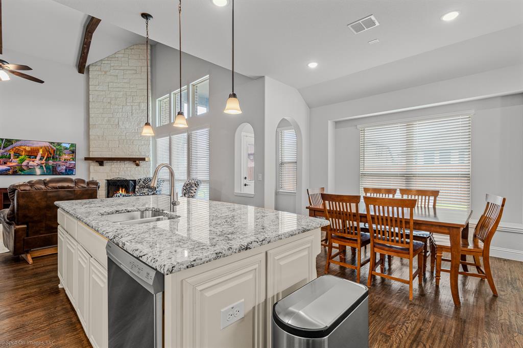 2139 Devonblue Drive Forney, TX 75126 - Photo 8 of 30 Kitchen with lofted ceiling, a sink, stainless steel dishwasher, dark wood finished floors, and ceiling fan