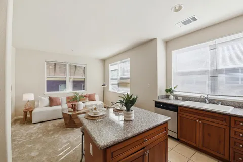 a view of a kitchen with a sink and living room