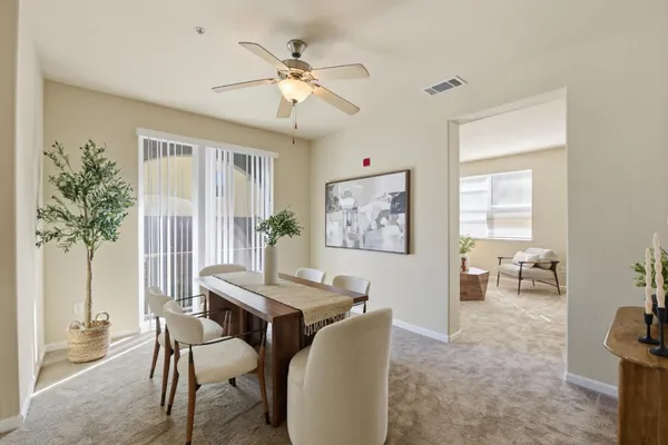 a view of a dining room with furniture and chandelier