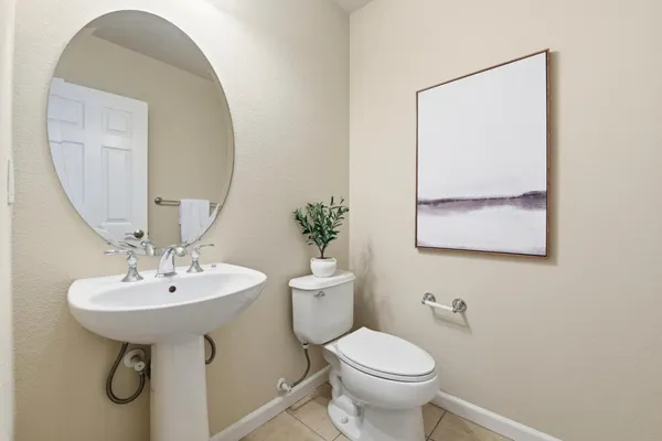 a bathroom with a sink toilet and a mirror