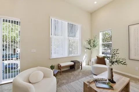 a living room with furniture and a potted plant