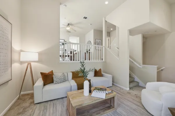a living room with furniture and a wooden floor
