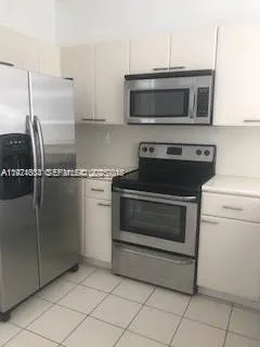 a kitchen with granite countertop a stove and a microwave