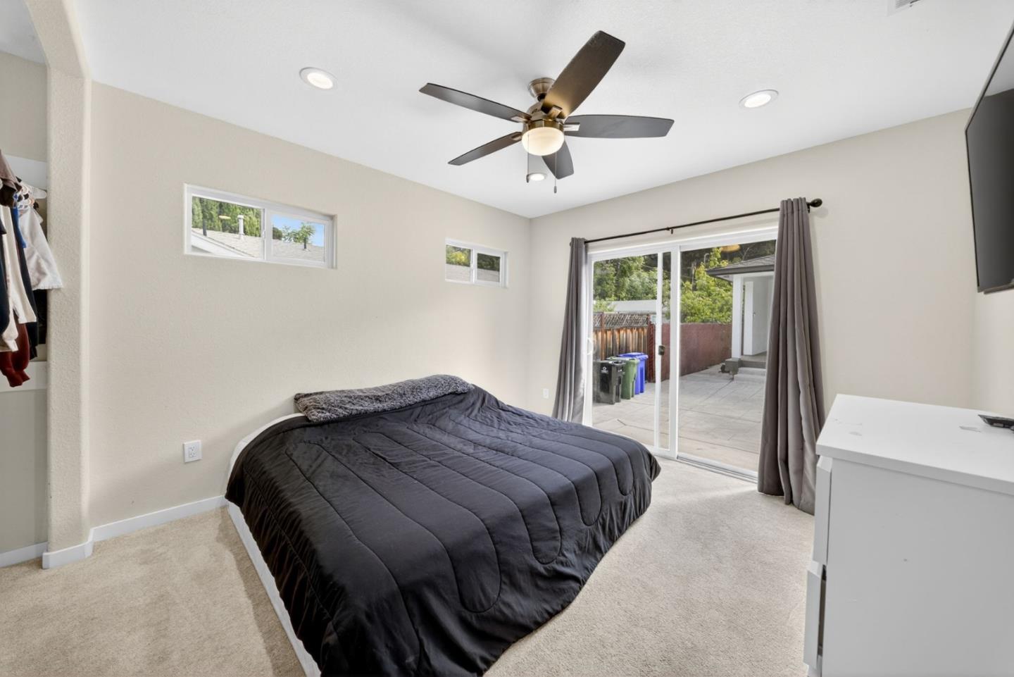 919 Old Canyon Road Fremont, CA 94536 - Photo 21 of 55 a bedroom with a large bed and a ceiling fan