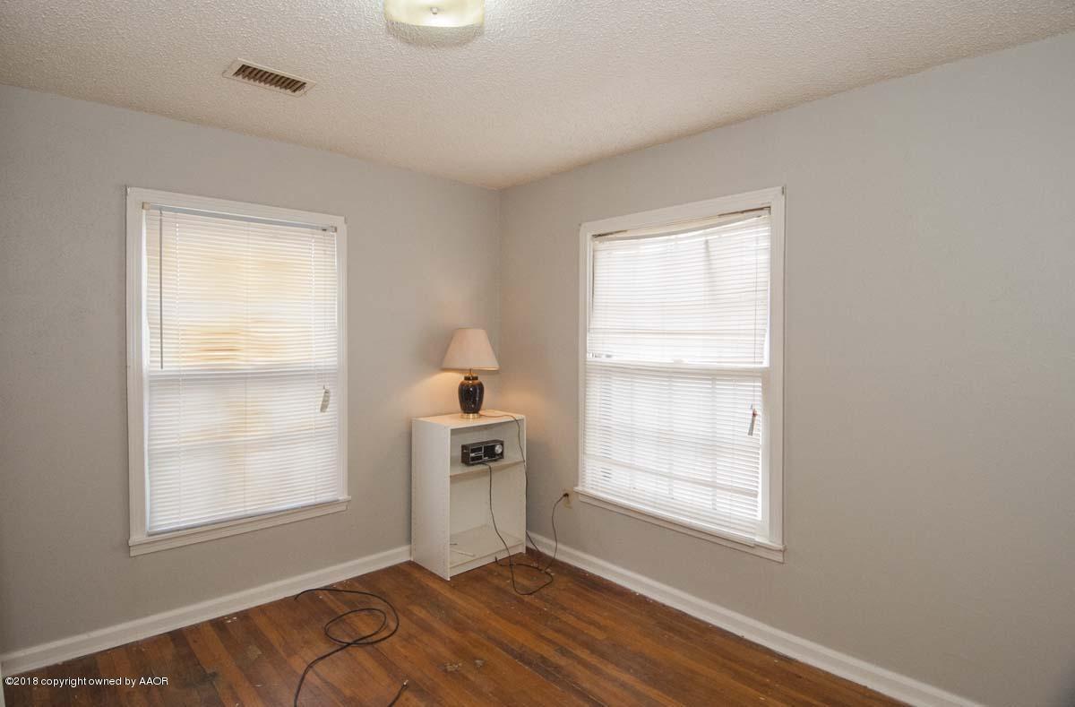 4211 South Harrison Street Amarillo, TX 79110 - Photo 12 of 22 a view of an empty room with a window and wooden floor