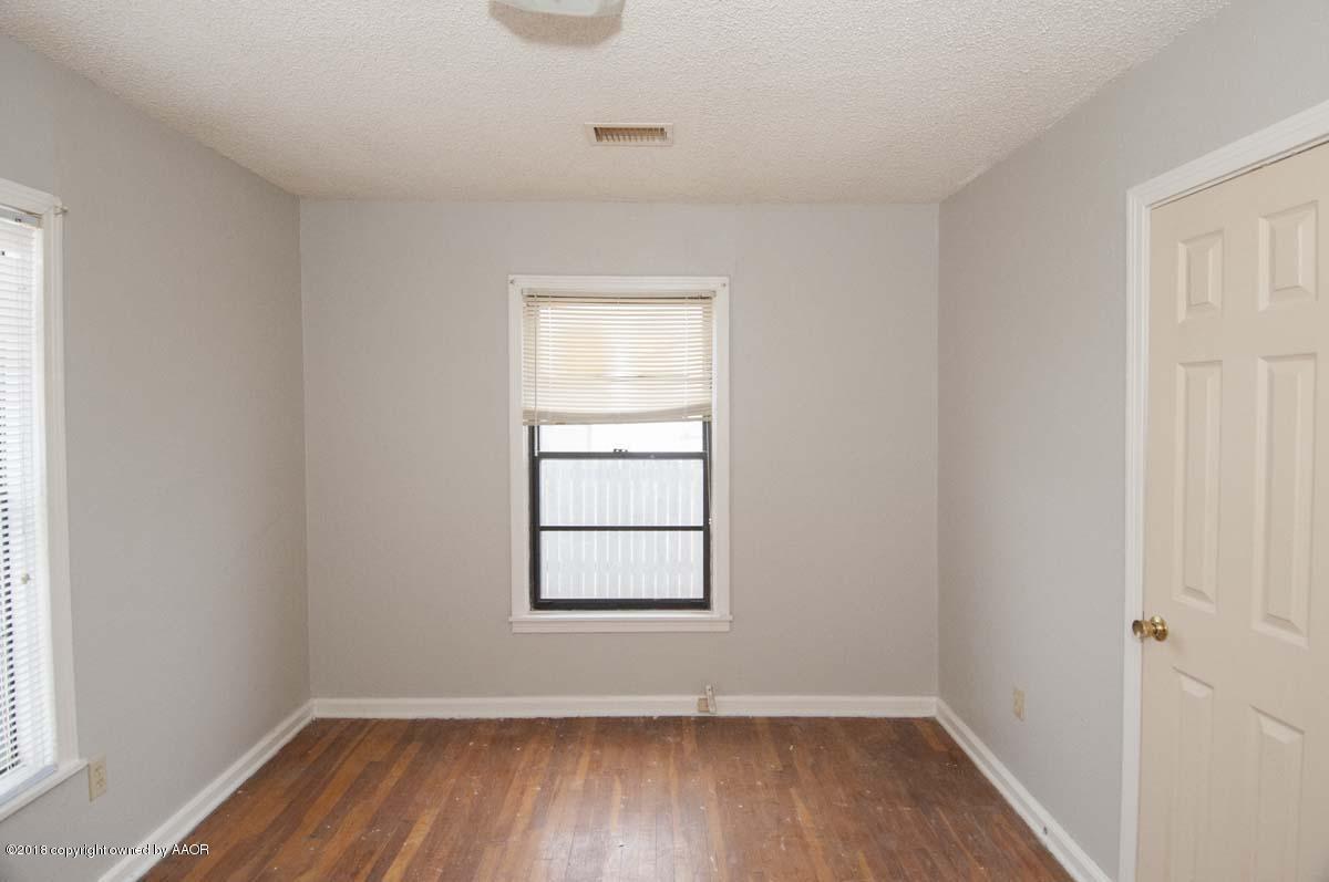 4211 South Harrison Street Amarillo, TX 79110 - Photo 15 of 22 an empty room with wooden floor and windows