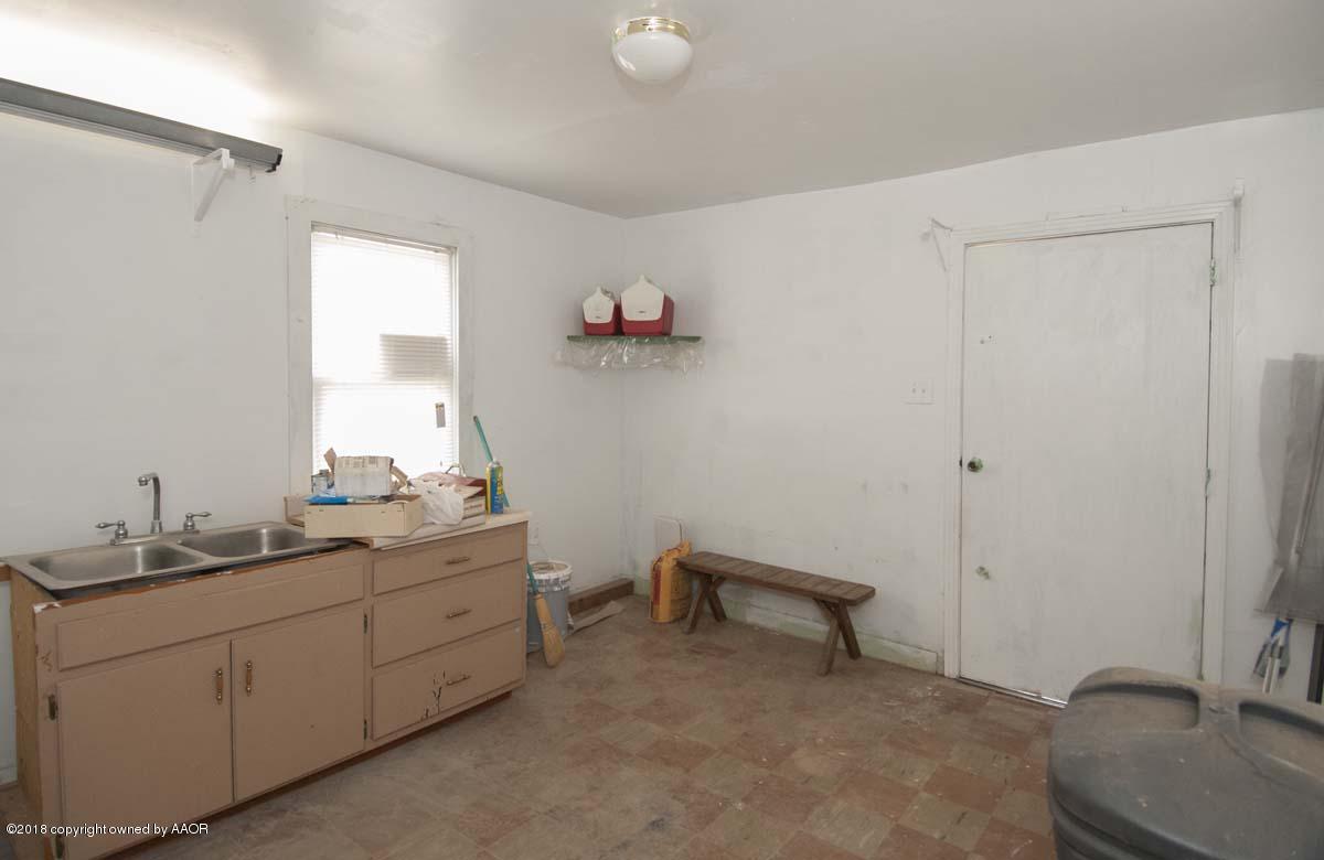 4211 South Harrison Street Amarillo, TX 79110 - Photo 18 of 22 a room with a chair and a dresser in it