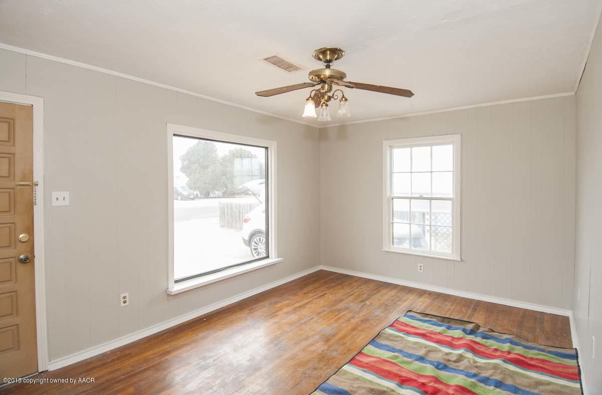 4211 South Harrison Street Amarillo, TX 79110 - Photo 2 of 22 a view of an empty room with a window and wooden floor