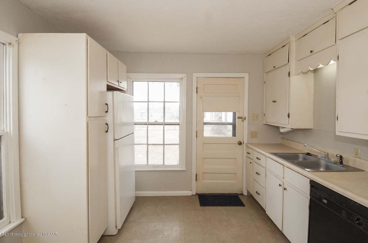 4211 South Harrison Street Amarillo, TX 79110 - Photo 4 of 22 a kitchen with white cabinets and white appliances