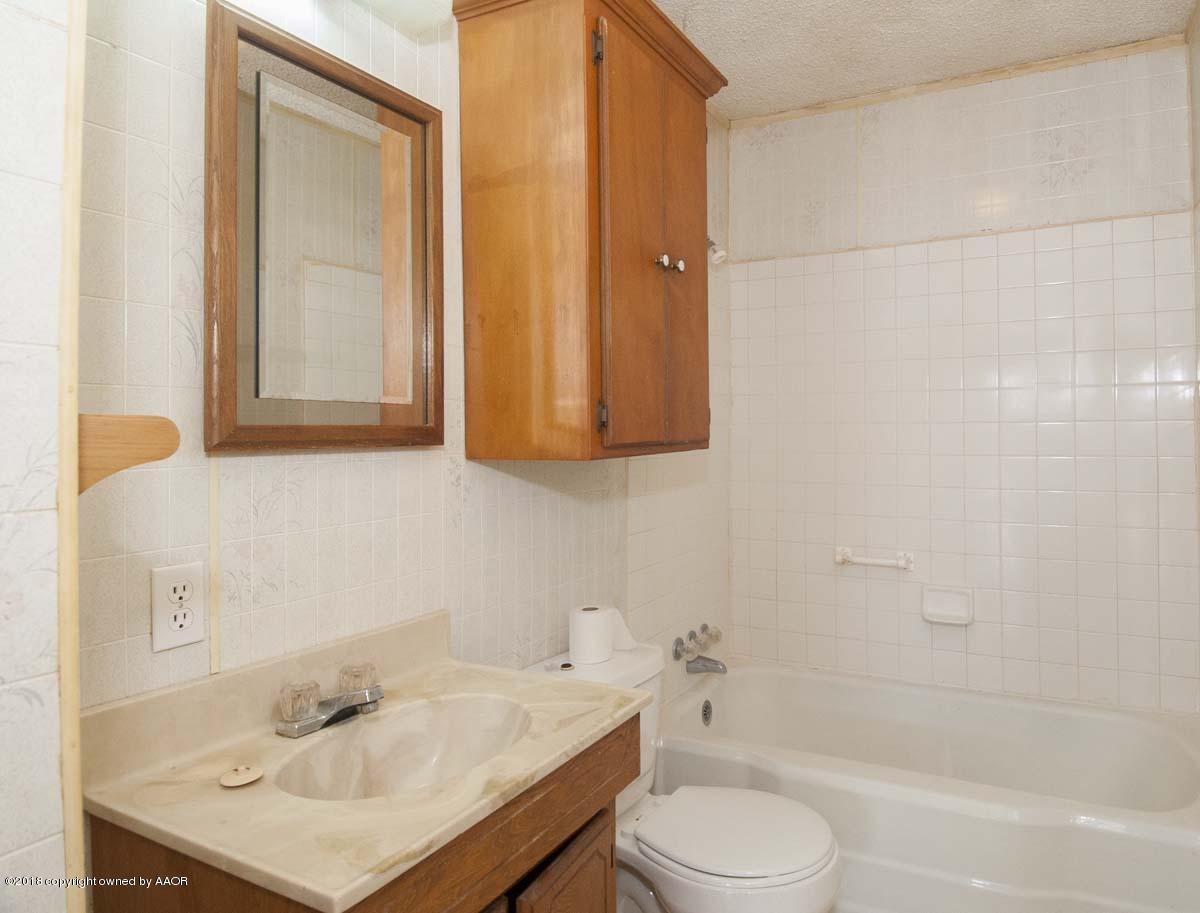 4211 South Harrison Street Amarillo, TX 79110 - Photo 5 of 22 a bathroom with a sink toilet and shower