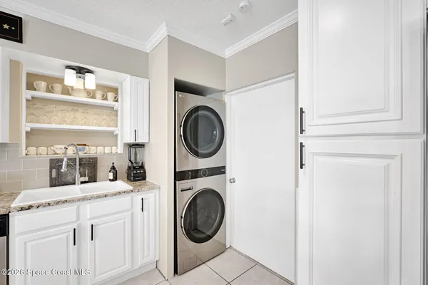 a kitchen with stainless steel appliances kitchen island granite countertop a stove a sink and a dining table with granite countertops