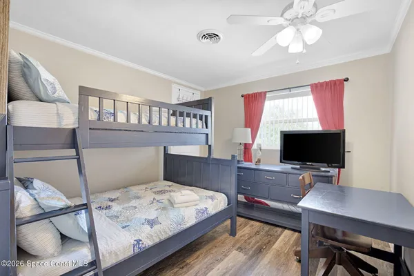 a bed room with furniture and a wooden floor