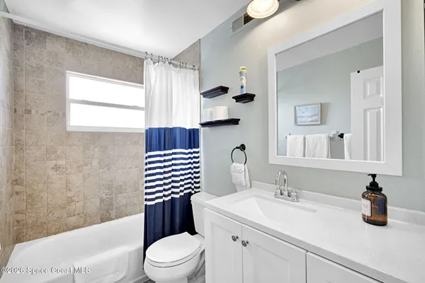 a bathroom with a sink mirror and toilet