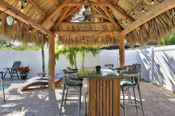 a view of a dinning table and chairs in patio
