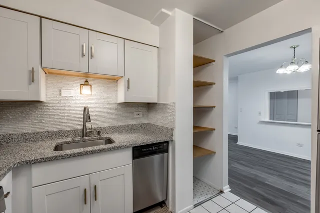 a view of a room with wooden floor and a ceiling fan