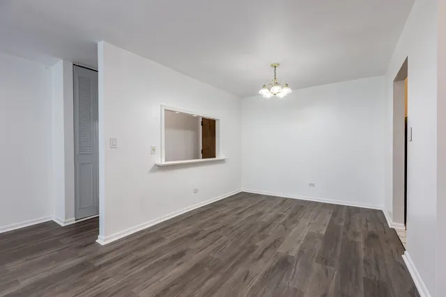 a view of a livingroom with wooden floor and a window