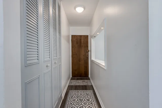 a view of a hallway with wooden floor