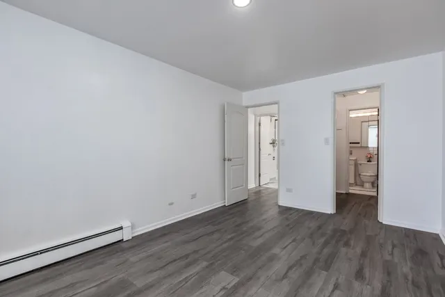 a view of wooden floor and windows in a room
