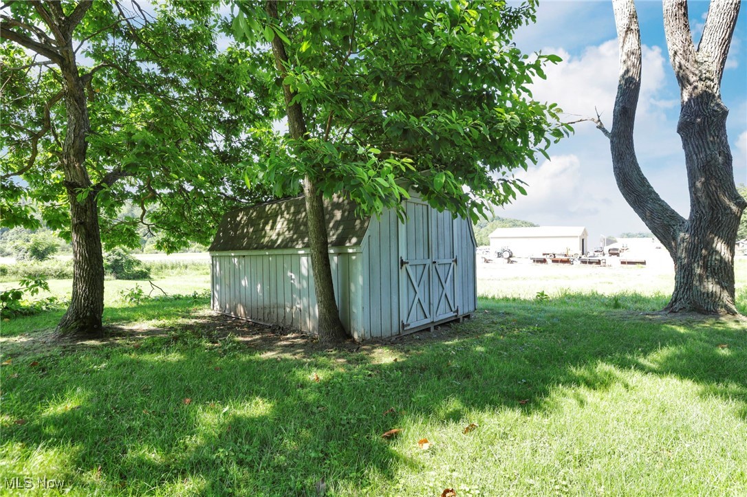 21372 Bridgewater Road Quaker City, OH 43773 - Photo 39 of 39 View of green lawn with a storage unit