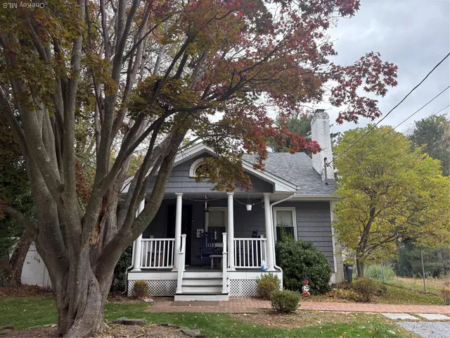 front view of a house with a tree