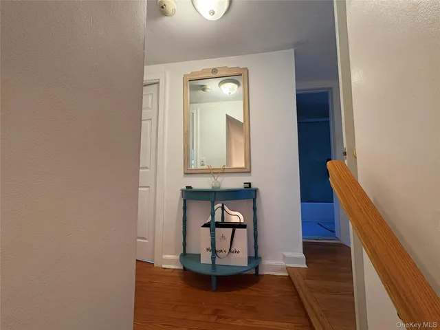 a view of a hallway with wooden floor and a hallway