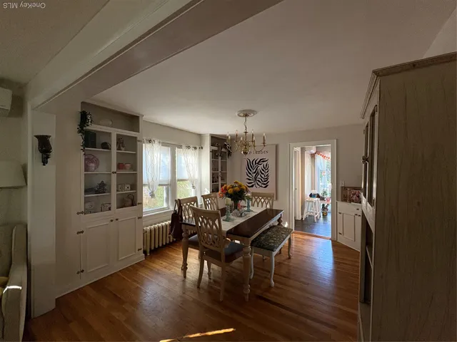 a view of a dining room with furniture window and wooden floor