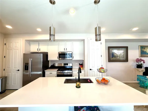 a kitchen with stainless steel appliances a refrigerator sink and stove