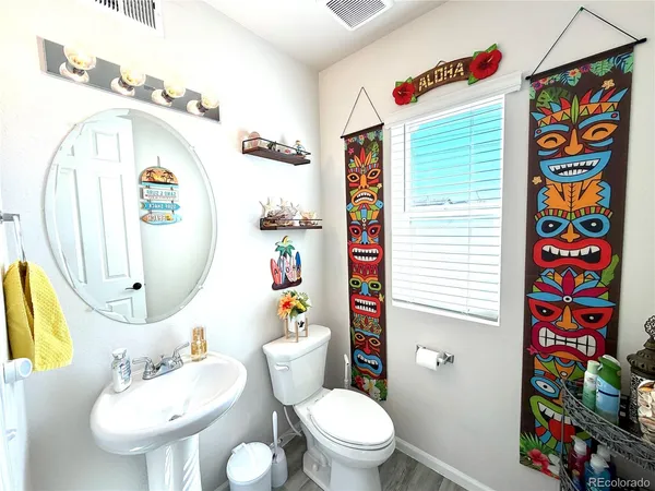 a bathroom with a sink a toilet and a mirror