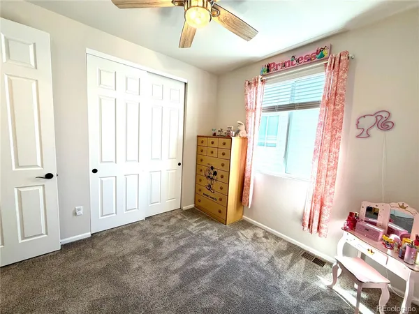 a view of a bedroom with furniture and window