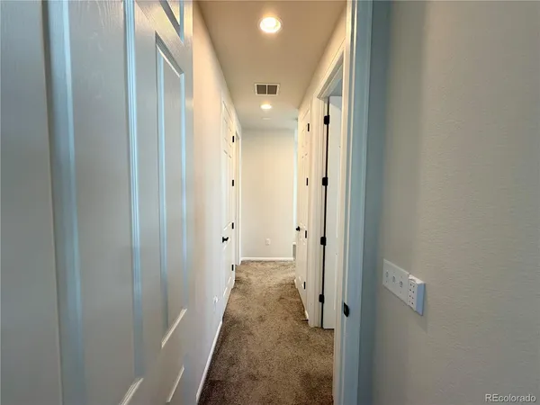 a view of a hallway with white walls