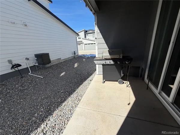 a backyard of a house with table and chairs