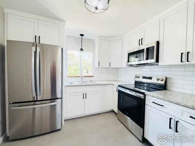 a kitchen with stainless steel appliances a refrigerator sink and microwave