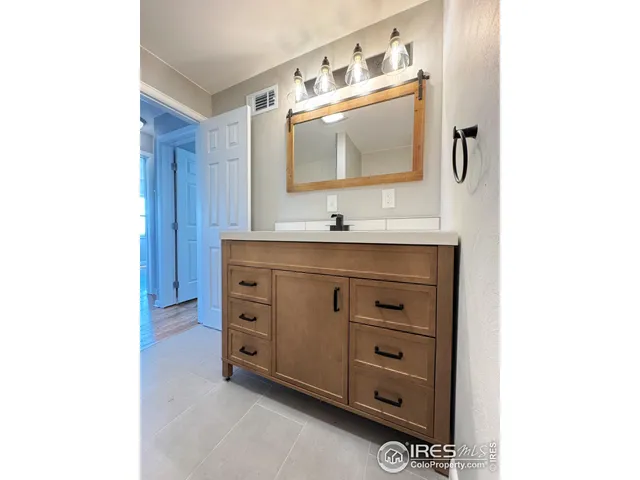 a bathroom with a sink a vanity and a mirror