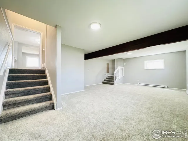 a view of empty room with stairs and fireplace