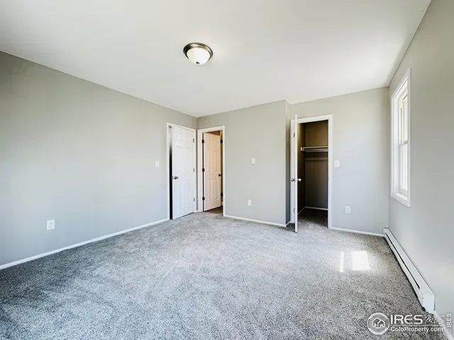 a spacious bedroom with a bed and a couch