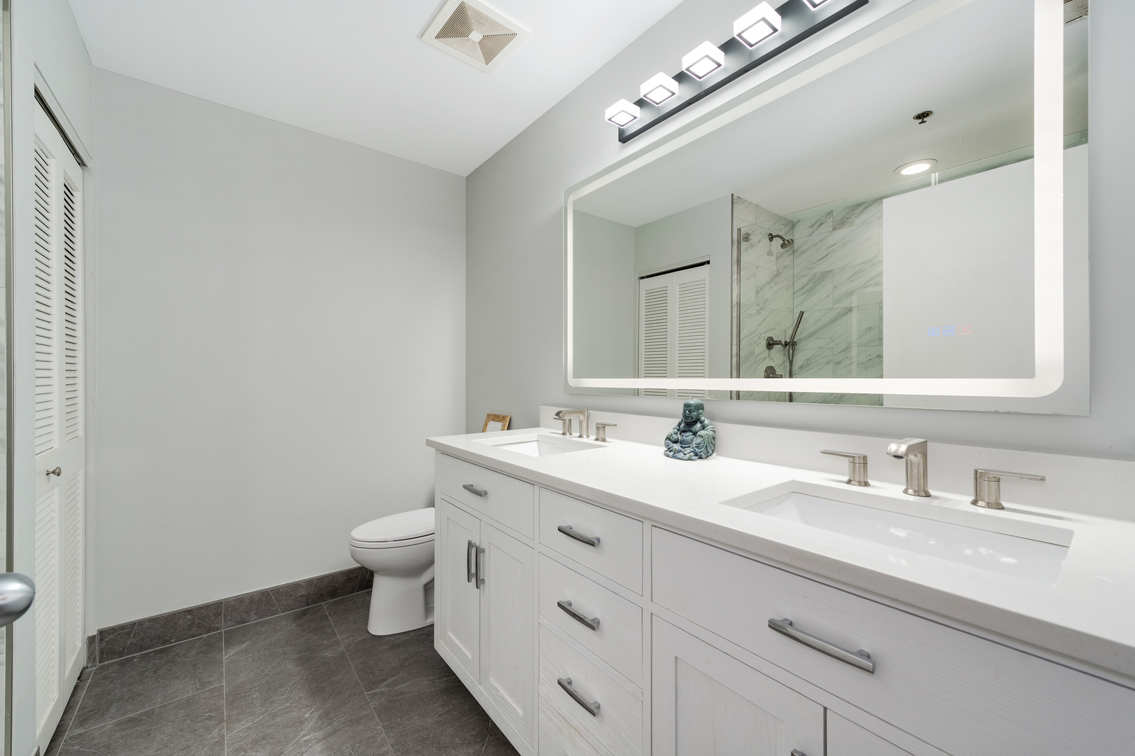 23 North Green Street, Unit 402 Chicago, IL 60607 - Photo 16 of 18 a bathroom with a double vanity sink mirror and toilet