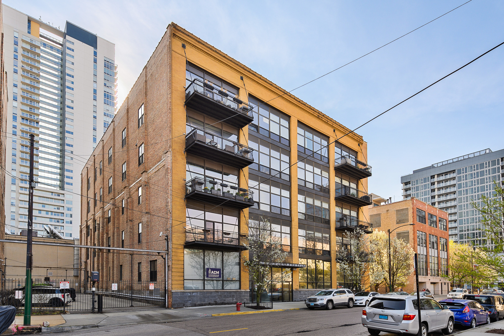 23 North Green Street, Unit 402 Chicago, IL 60607 - Photo 2 of 18 a city street lined with buildings and cars