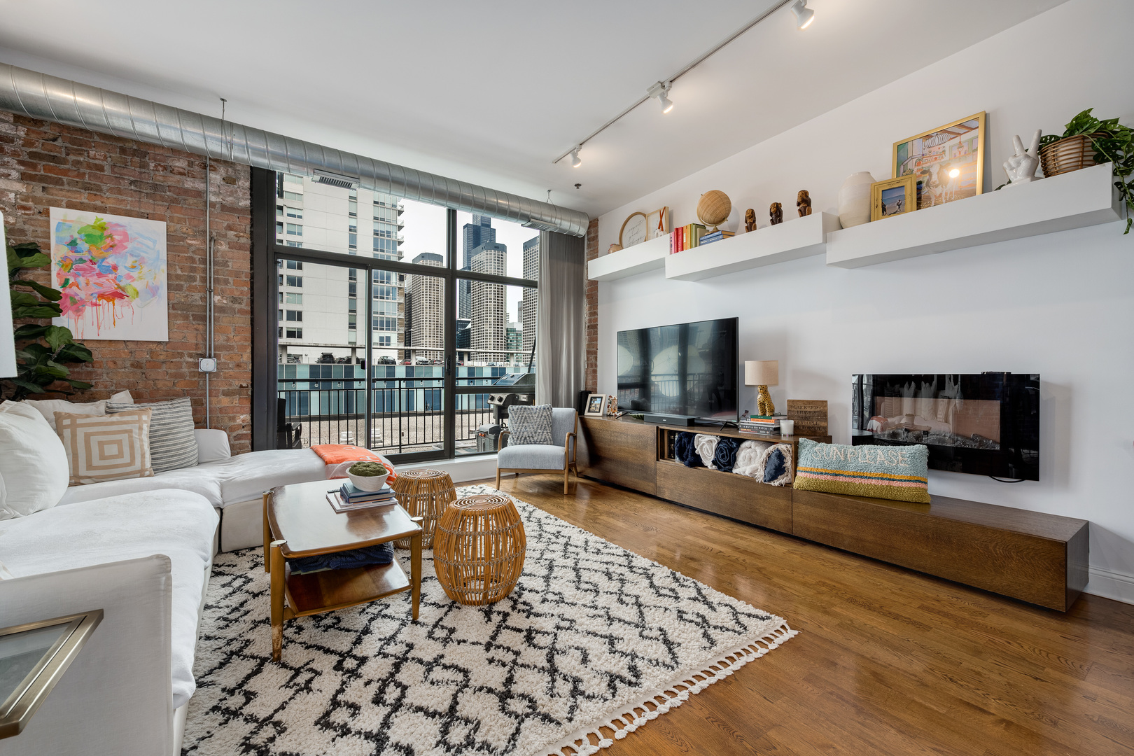 23 North Green Street, Unit 402 Chicago, IL 60607 - Photo 6 of 18 a living room with furniture large window and a flat screen tv