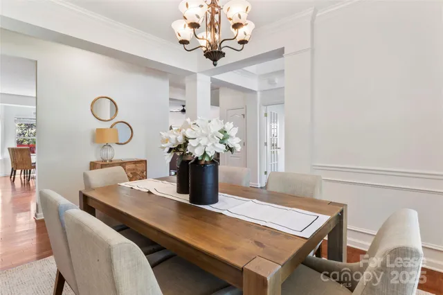 a dining room with furniture and wooden floor
