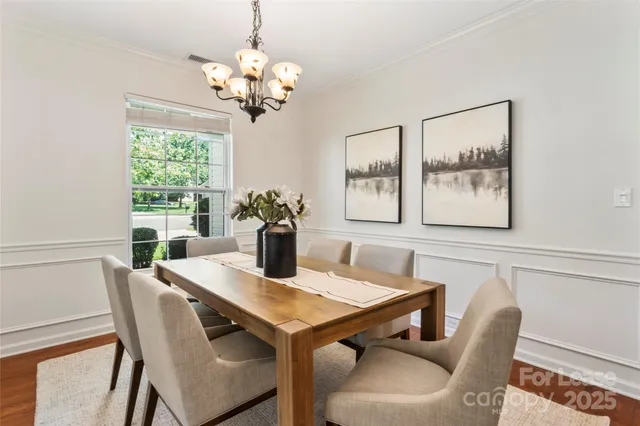 a view of a dining room with furniture and chandelier